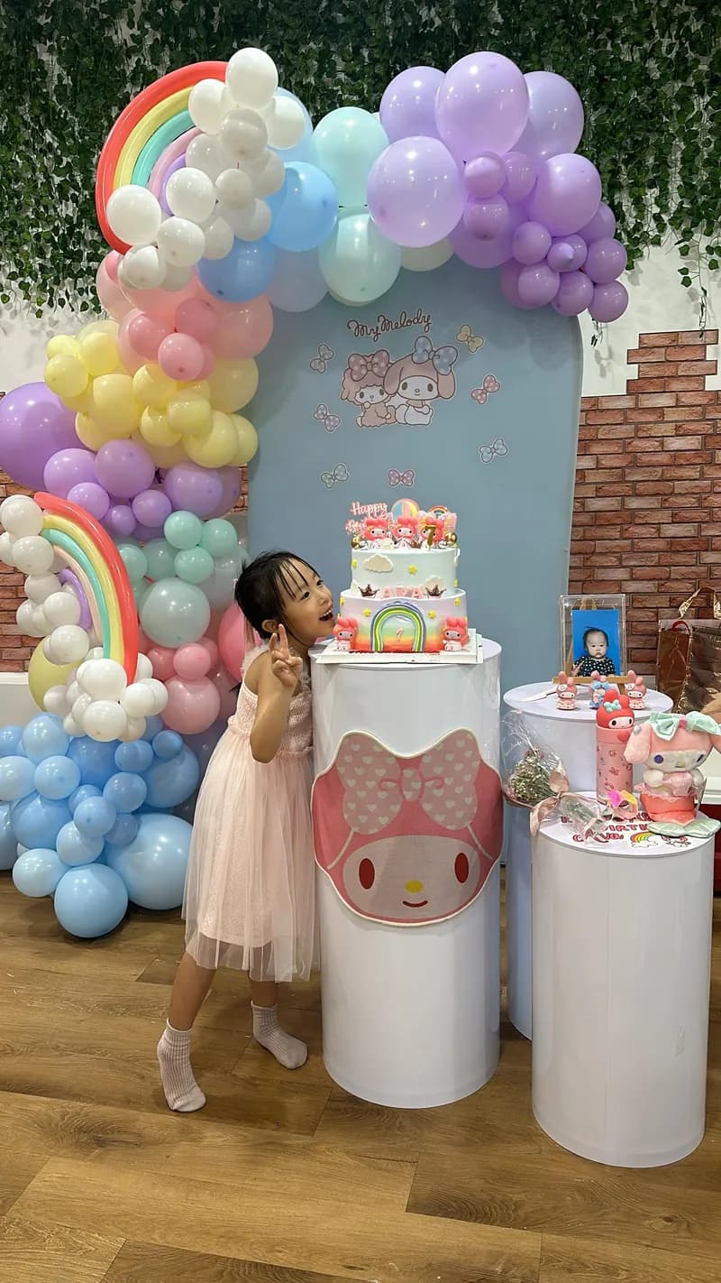 Birthday child blowing out the candles on the cake at a Play Kingdoms party